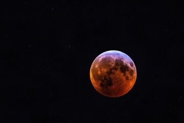Fototapeta na wymiar the blood moon is seen during a lunar eclipse in this photograph