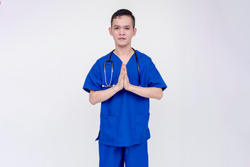 A tearful and and miserable medical student or nurse or intern apologizing with both her hands clasped together. Isolated on a white background.