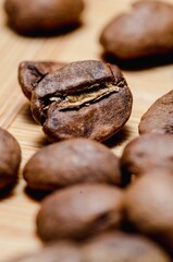 Beautiful closeup of coffee beans on wooden background