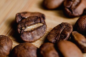 Beautiful closeup of coffee beans on wooden background