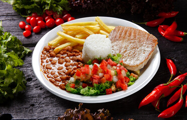Rice, beans, grilled pork, salad and french fries