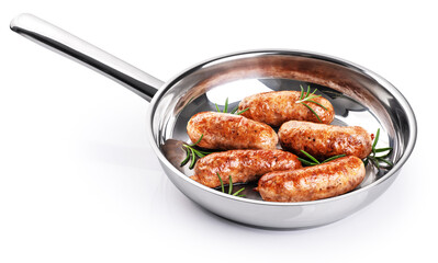 Sausages with rosemary fried in a stainless steel pan isolated on white background. With clipping path.