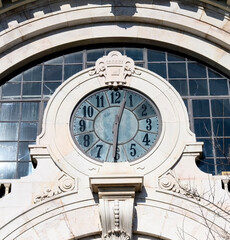 Fototapeta na wymiar Clock in the architectural capital of the Time Out Market in Lisbon, Portugal. 