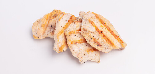 Grilled pieces of chicken breast on a white background. Grilled food with shadows, grilling season - obrazy, fototapety, plakaty