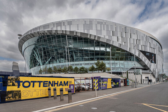 The front of Tottenham Hotspur's White Hart Lane stadium with cloudy skies with the word 'Tottenham' on the signage at the front
