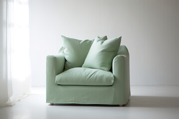 Modern armchair with green linen cover on light background