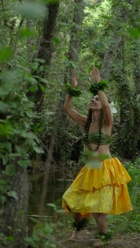 Hula dancer performing art and culture of hawaii in the middle of the jungle connecting with nature in a personal wellness ritual. Hawaiian dance danced in the forest Hula dance.