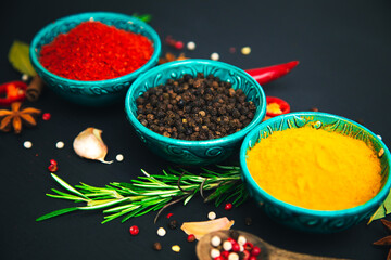 Spices and seasonings for cooking on a dark background.