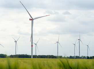 multiple wind turbines in grass fields