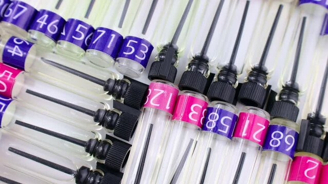 Many perfume samples, colognes and fragrances tester bottles circle rotation close up top view