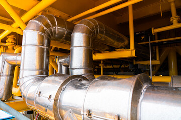 Naklejka premium Heating medium oil pipeline protected with stainless steel insulation for keep temperature form environment, offshore oil and gas central processing platform piping system.