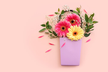 Top view image of beautiful flowers composition over pastel pink background