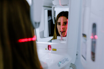 Young woman in dental x ray digital scanner in bright clinic