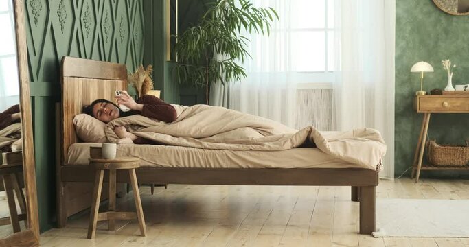 Caucasian woman in pajamas awake by the sound of a ringing phone. She answers the call, however, as the realization of being late dawns upon her, she quickly springs into action.