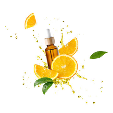 Brown glass bottle of face serum with vitamin C or essential oil and orange slices flying in splashing liquid isolated on white background
