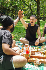 Group of friends enjoying a picnic together in the park