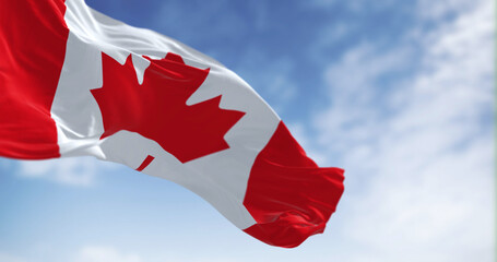 Canada national flag waving in the wind on a clear day - obrazy, fototapety, plakaty