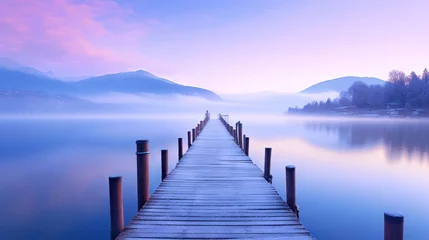 Tuinposter  a dock on a lake with mountains in the background at dusk with fog on the water and a few clouds in the sky above it.  generative ai © Oleg