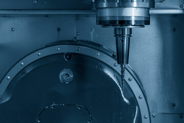 Close up scene the  spindle with taper tool cutter on 5-axis CNC milling machine.