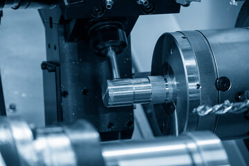 Obraz na płótnie Canvas The CNC lathe machine milling cut the metal shaft parts by milling spindle.
