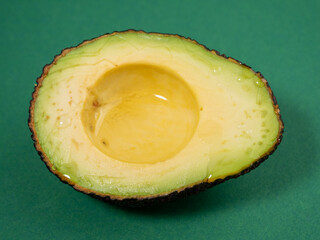 Avocado on a green background. Ripe avocado.