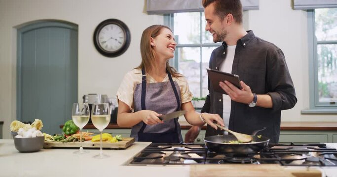 Cooking, kitchen and couple with tablet for recipe online for lunch, supper and romantic dinner. Happy, love and man and woman on digital tech on internet for meal prep, instructions and food website