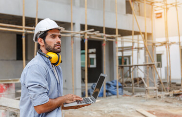 Young architect engineering consultant using laptop on construction site inspecting building, inspecting, designing and planning