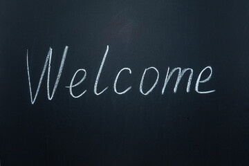 Inscriptions and phrases in chalk on a blackboard. Welcome.