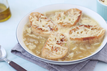 A ceramic bowl with French onion soup