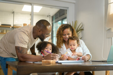 Happy African American parent playing and drawing with daughters in home