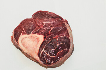 Fresh piece of meat big beef steak on the bone ossobuco.