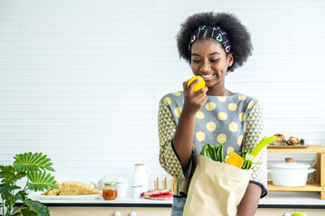 Young happy woman african american afro hair have just returned from the market. and took the...