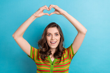 Fototapeta na wymiar Photo of funky young girl showing fingers love symbol sympathy send boyfriend heart valentine day gift isolated on blue color background