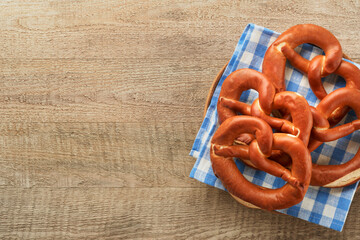 Oktoberfest concept card. Traditional Bavarian pretzels with beer bottle mug on old rustic wooden background. Perfect for Octoberfest. Oktoberfest food menu. Top view. Mock up.