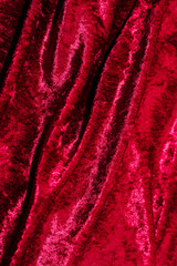 Fototapeta premium Texture of red velor corduroy fabric with folds.