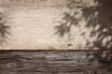 Sepia colored background with plant shadows on weathered wooden wall for a product placement....