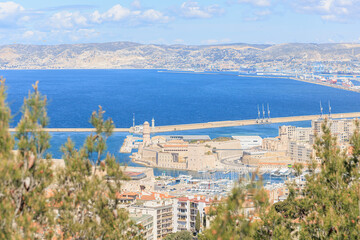 A scenics aerial view of the old port (vieux port) of Marseille, bouches-du-rhône, France under a majestic blue sky and some white clouds