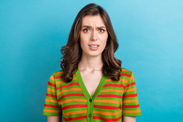 Fototapeta premium Portrait of dissatisfied gorgeous woman with wavy hairdo dressed colorful cardigan staring nervous isolated on blue color background