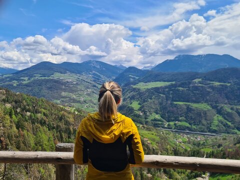 Beautiful view to the Dolmites. Girl enjoyes the view while hiking. Italian Alps. Fantastic landscape