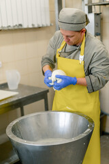 production of dairy cheeses the cheesemaker sculpts fresh mozzarella with his hands and stretches the cheese