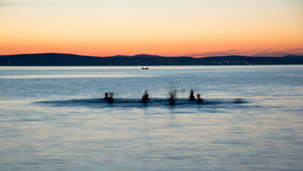 Fototapeta na wymiar bathers in Lake Balaton at sunset