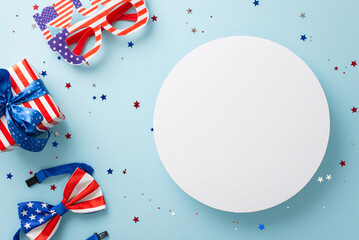 Obraz premium Setting the mood for American Independence Day. Top view party decorations featuring confetti, party eyeglasses, bow-tie in national flag colors, giftbox, on a blue backdrop with circle for text or ad