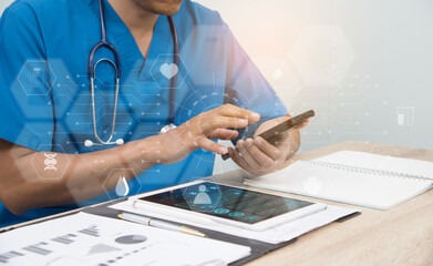Smart medicine doctor working with computer notebook and digital tablet at desk in the hospital. Medical concept, futuristic virtual interface screen