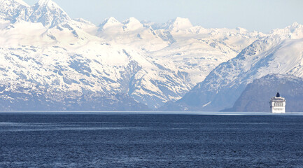 Cruise Ship dwarfed by High Snowcapped Mountains.  Glacier Bay National Park, Alaska.  **Note,  Optical Telephoto Compression, Ship appears out of focus due to Heat Haze**