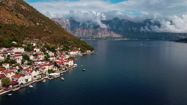 Aerial drone high view of Kotor bay, Boka Kotorska and coastal town Kotor, Cattaro, in Montenegro. Location place famous resort Montenegro. Adriatic fjord surrounded by rugged mountains.