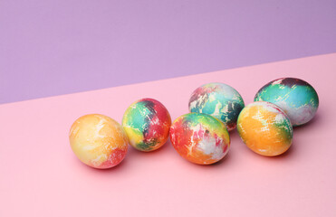 Fototapeta na wymiar Easter colored eggs on pastel color background. Minimalism Easter still life