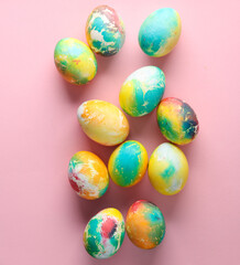 Multicolored Easter eggs on a pink background