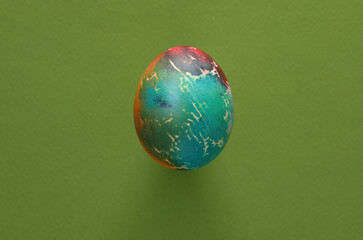 Multicolored Easter egg on green background
