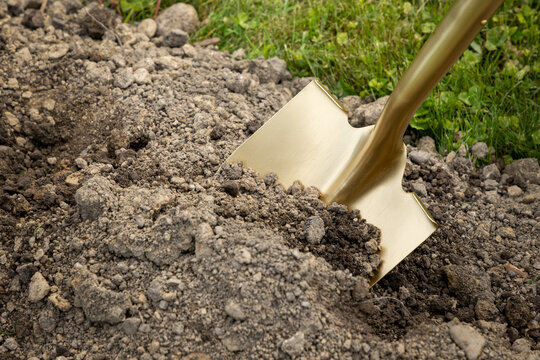 ground breaking event with golden shovel in dirt, being of construction