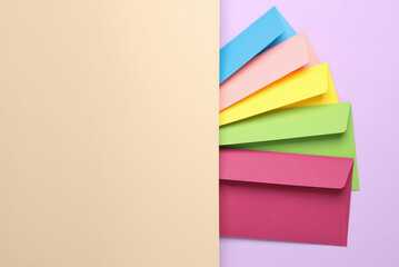 Group of colored envelopes on pastel paper. Creative layout